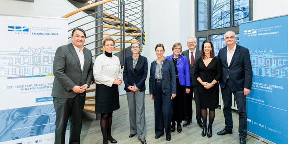 Several university representatives stand side by side celebrating the opening of the College for Social Sciences and Humanities. The rectors of the participating universities, a minister and members of the academic management team can be seen.